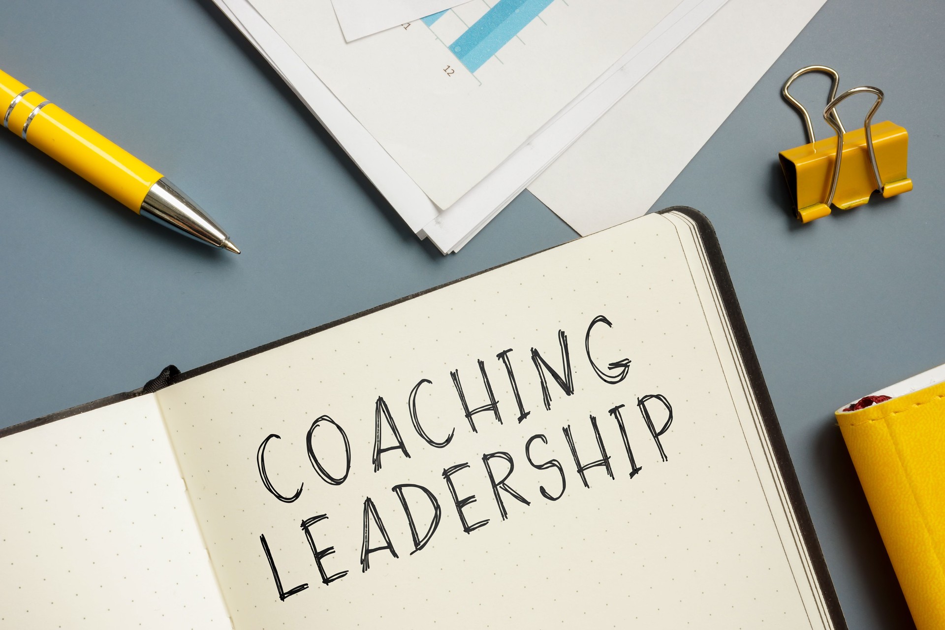 Marks about coaching leadership in the notepad.